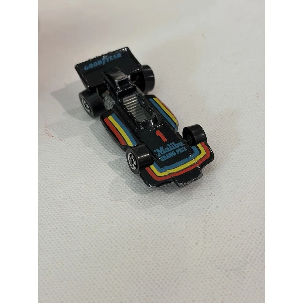 1982 Hot Wheels Malibu Grand Prix 1973 Malaysia Blackwalls Metal Base Black #1